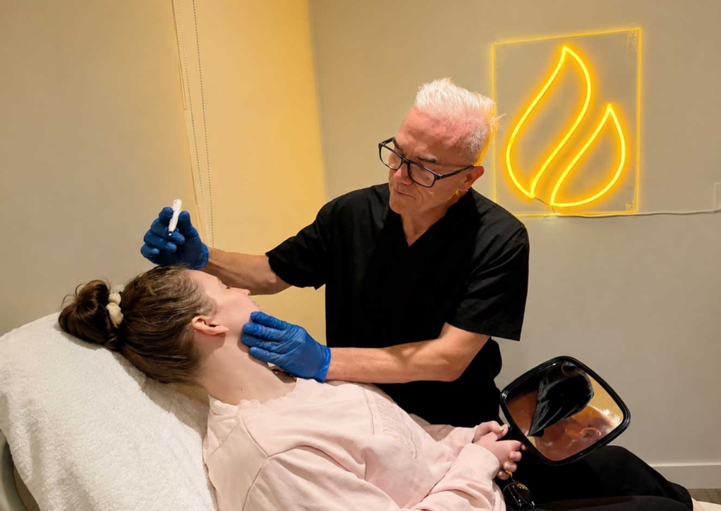 Corey Anderson RN consulting with a cosmetic patient at Core Aesthetics in Oakleigh, Melbourne before discussing non-surgical cosmetic treatment options.