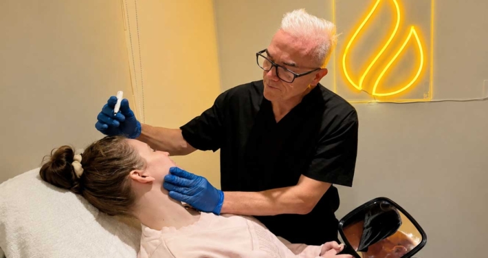 Corey Anderson RN consulting with a cosmetic patient at Core Aesthetics in Oakleigh, Melbourne before discussing non-surgical cosmetic treatment options.